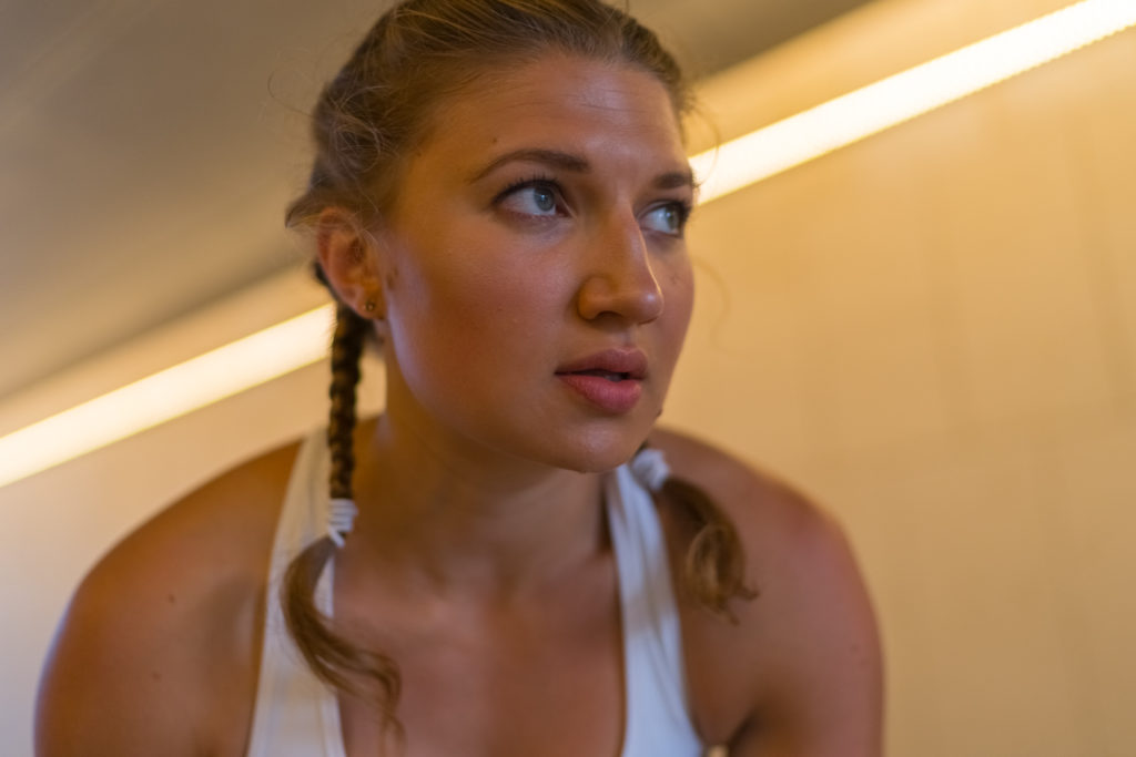 Caucasian Female Athlete is taking a break from her training outdoor. Portrait