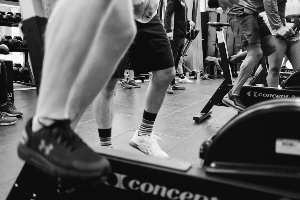 Close up of Anonymous Legs training with Bikes During a Crossfit Competition. Black and White image