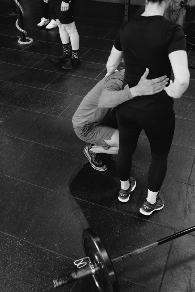 An Nonymous Man is hugging His Femlae Crossfit Teammate at the end of the Competition. Black and White Image