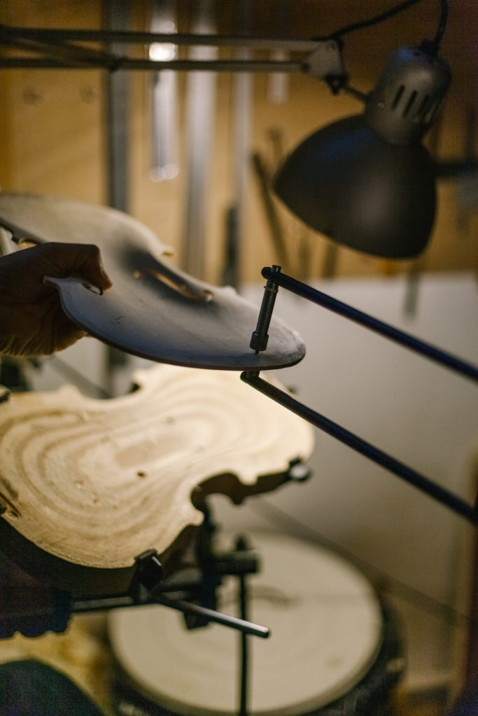 Anonymous Italian Violinmaker measures the Thickness of the Handmade Violin while is working from his workshop