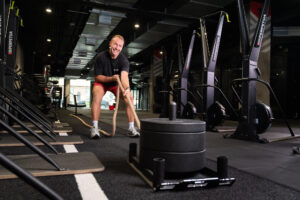 Man dragging a sled with a rope during strength training at Perpetua Gym Dublin.